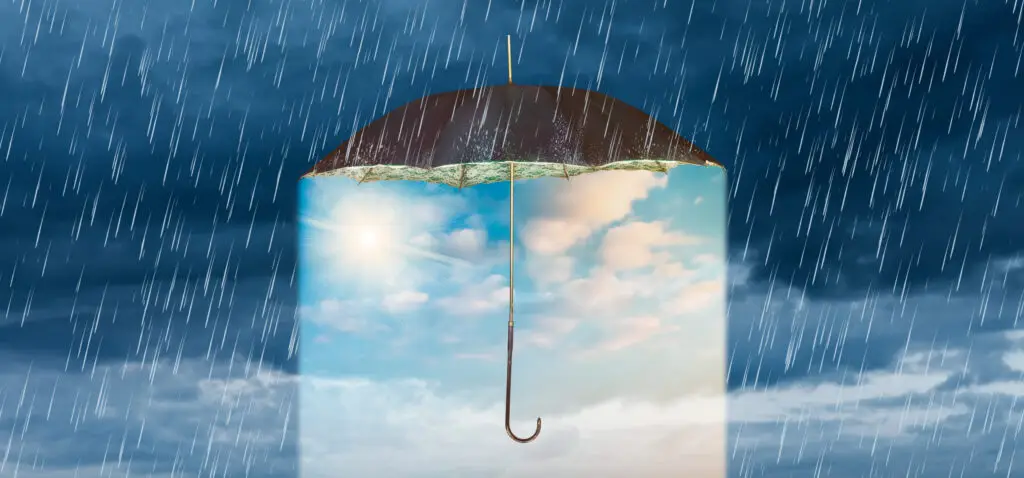 Optimism shelter from the rain create a virtuous cycle. Image of umbrella in a rainstorm