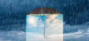 Optimism shelter from the rain create a virtuous cycle. Image of umbrella in a rainstorm